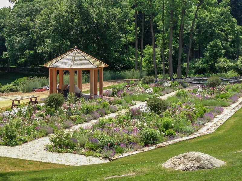 Newly built gazebo and young plantings with sawhorses and tools still on site