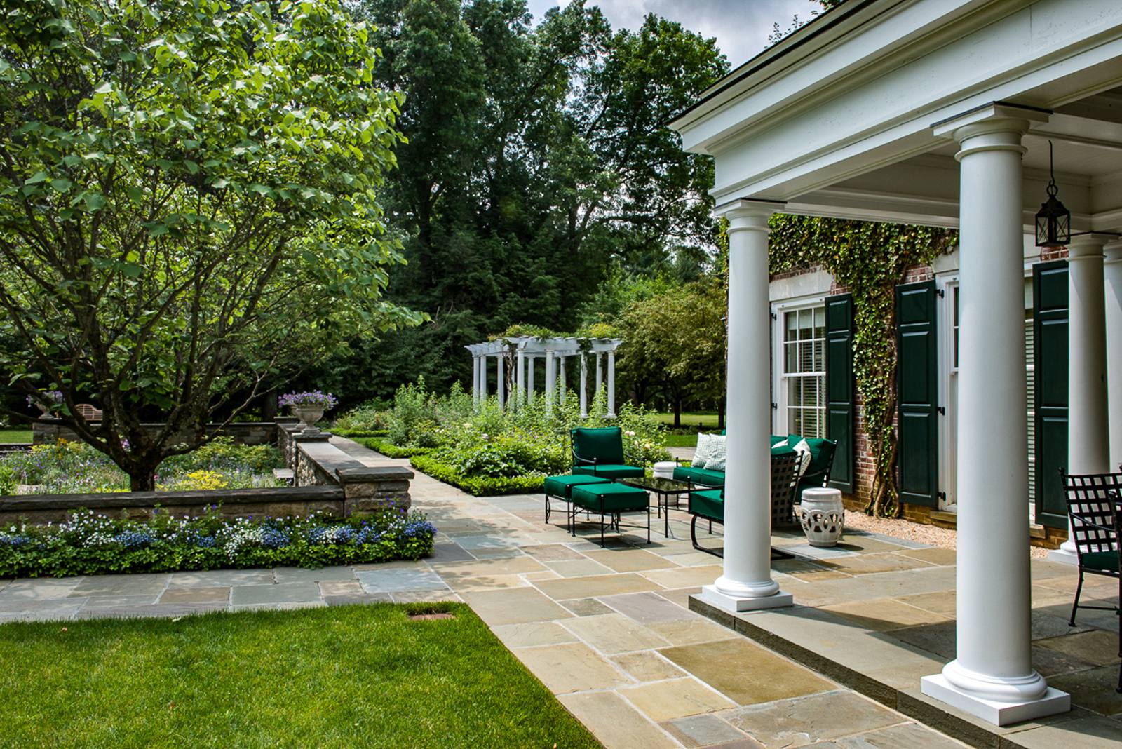Bluestone terrace with columned porch and pergola